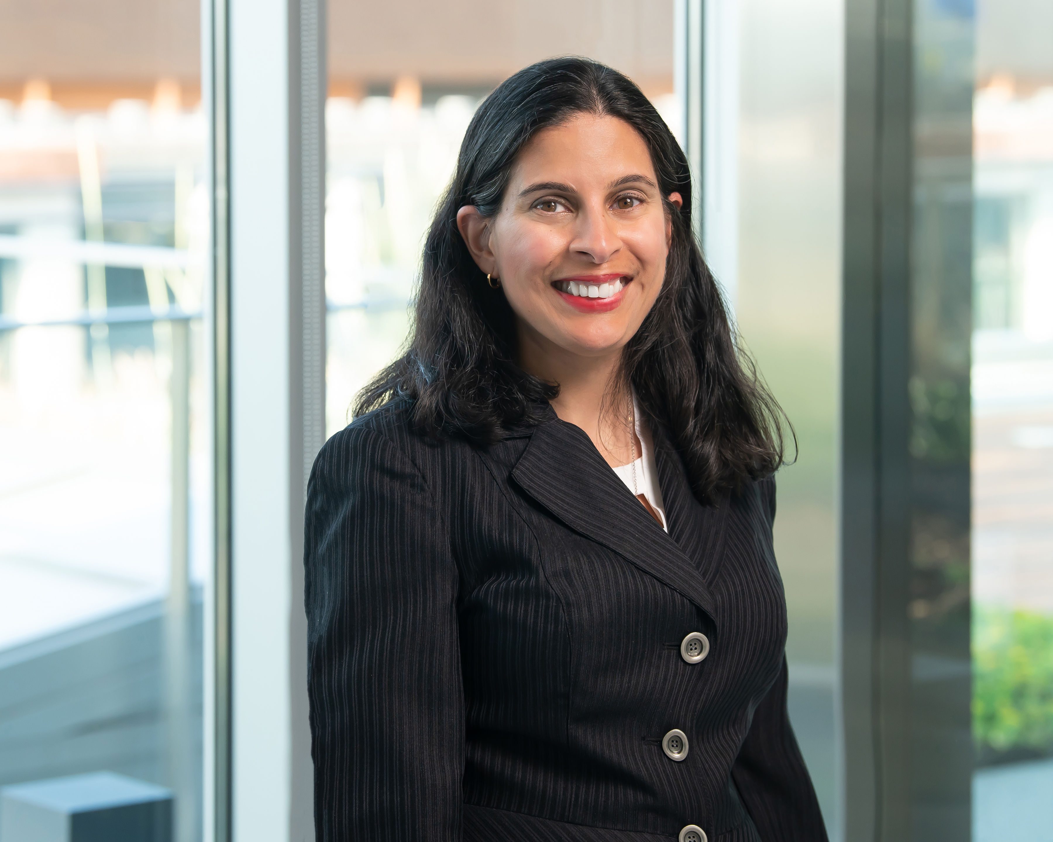 female thriving at work wearing striped suit